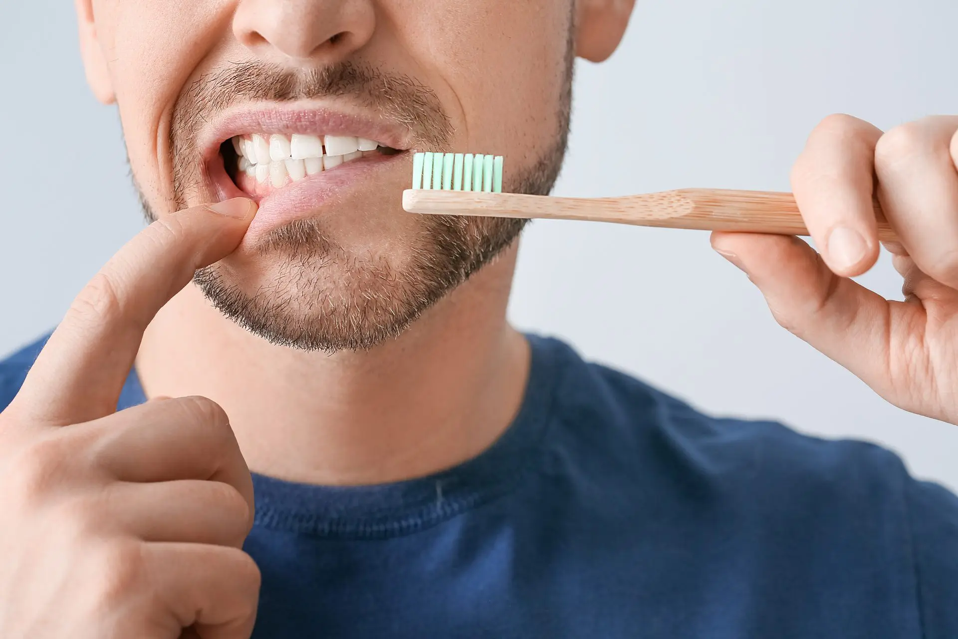Man Brushing His Teeth After Wisdom Tooth Removal